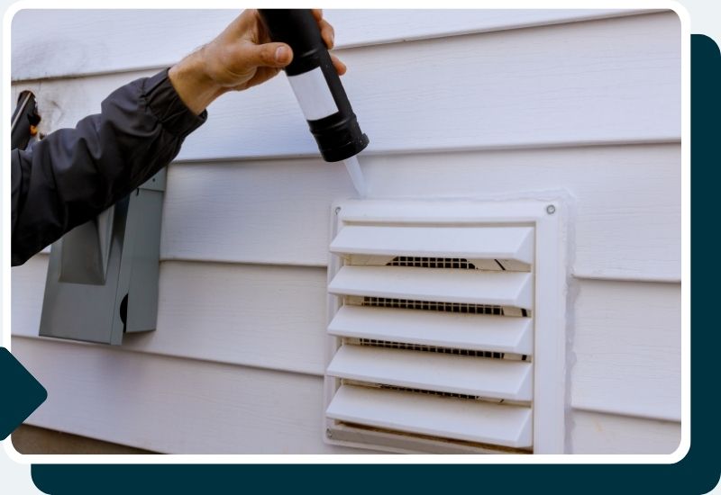 a professional caulking a dryer vent